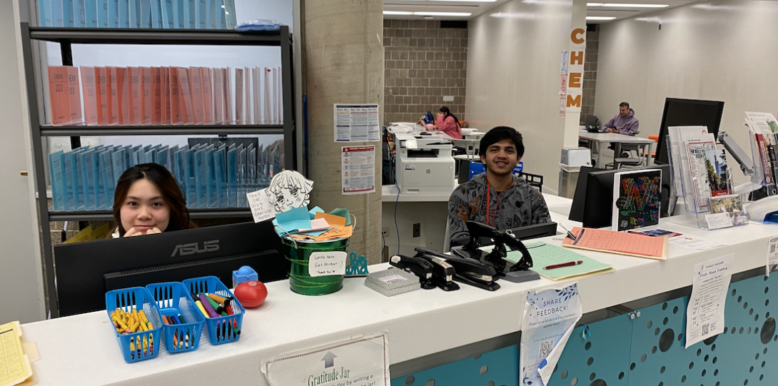 student team members working at the main desk