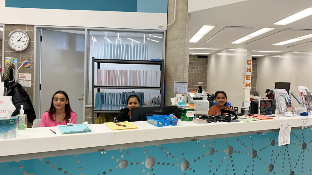 Three ambassadors sit at the main desk of the MSLC